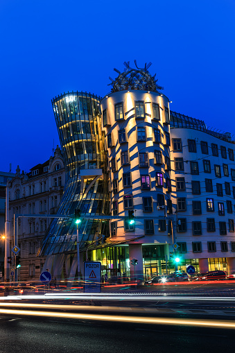 Praque, Czech Republic, May 05.2023: The Dancing House, or Fred and Ginger in the evening illumination, designed by Frank Gehry is the modern landmark of Prague