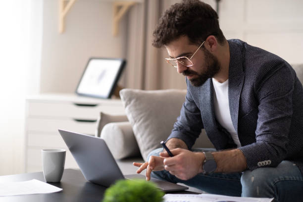 istock Handsome businessman working in Home office. 1497711525