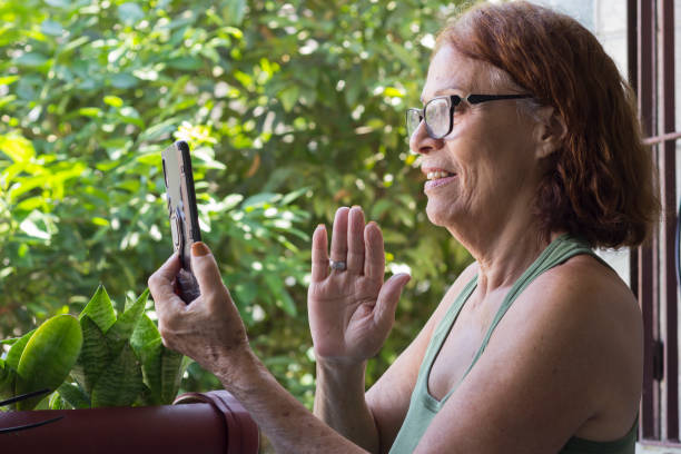 istock Smiling mature woman enjoying the smartphone technology to communicate 1497712193