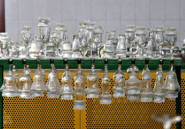 Glass cups on a conveyor belt for further processing. glass factory