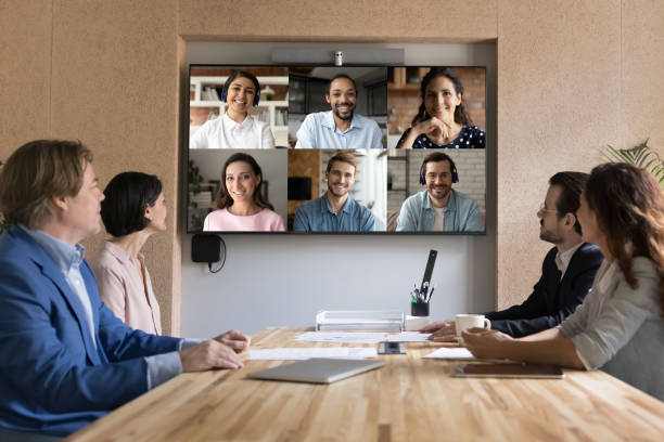 istock Multiethnic applicants on TV screen during group job interview event 1497712458