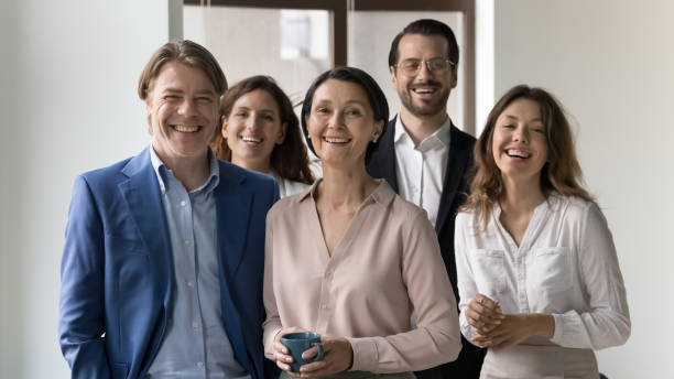 istock Group of businesspeople standing in office looking at camera 1497712600