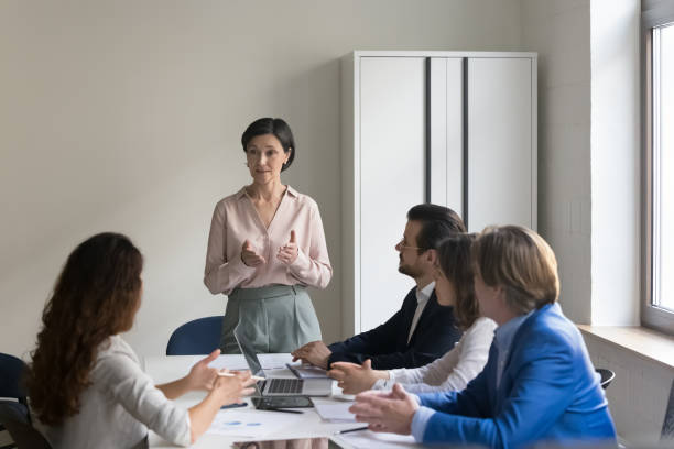 istock Executive team listen to mature female CEO presenting project plan 1497712606