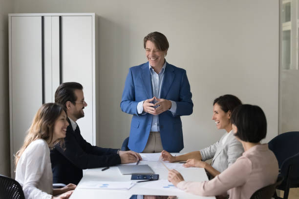 istock Happy mature boss gives presentation for clients in conference room 1497712616