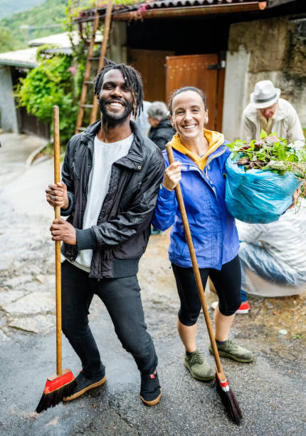istock Smiling volunteers working during a community cleanup 1497713389