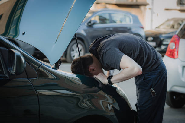 istock A young man takes out a car headlight bulb. 1497713836