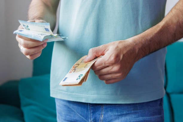 istock Hands of man counting euro bills 1497714173