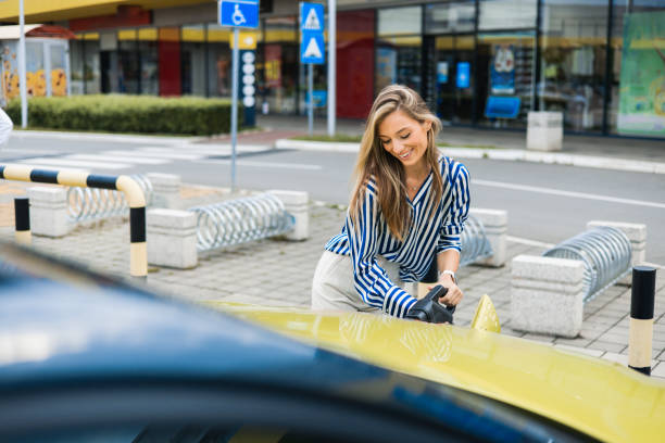 istock Young woman is charging an electric car 1497721689