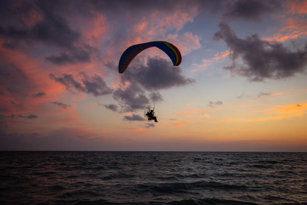 Sunset Paragliders Watching paragliders on the west coast of Florida at sunset adrenaline stock pictures, royalty-free photos & images