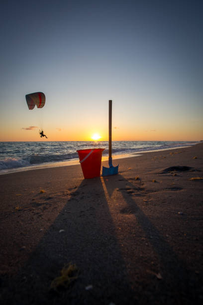 istock Bucket and shovel on the beach at sunset 1497722822