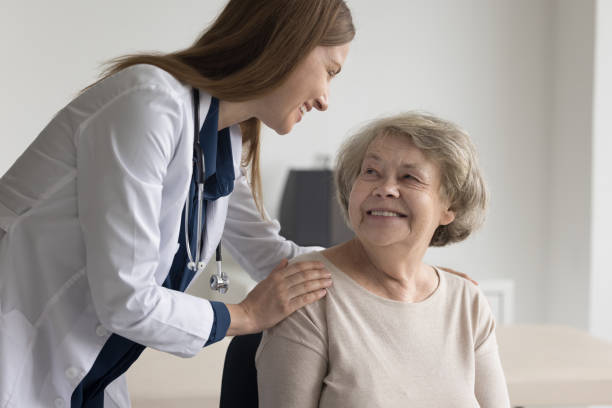istock Positive female geriatrician calming old patient, touching shoulders 1497725206