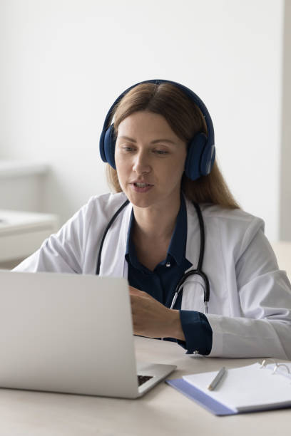 istock Female practitioner giving online consultation, advice, help to patient 1497725226