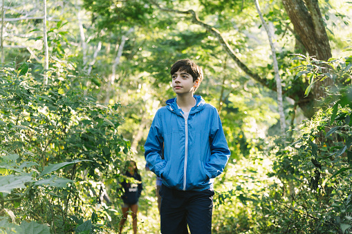 Teenage boy on forest trail