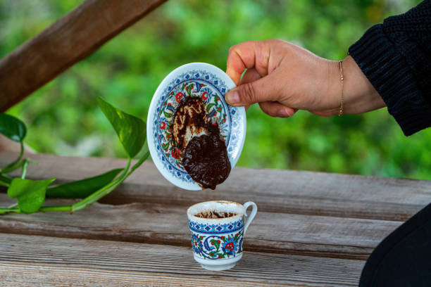 Coffee fortune telling in a classic patterned Turkish cup. Coffee grounds stock photo