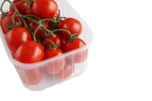istock Plastic tray with red cherry tomatoes with sepals isolated on the white background. Tomato pile. Ripe and fresh organic vegetables harvested from local farmers. Clipping path. Top view. Copy space. 1497729929