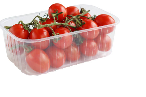 Cherry tomatoes in a plastic container. Fresh cherry tomatoes in box on white background.