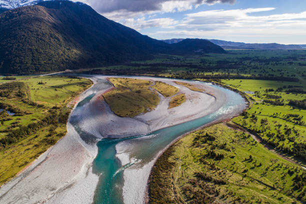 istock Aerial perspective of river braid system in valley from glacial runoff with scenic snow covered mountains 1497731076