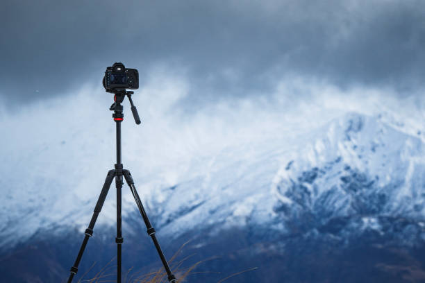 istock Camera equipment on tripod setup taking photographs of dramatic mountain landscape 1497731968