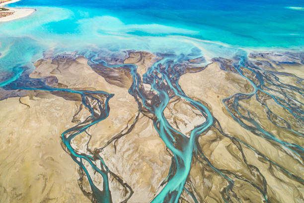 istock Aerial perspective of river braid system into turquoise lake from glacial runoff 1497732180