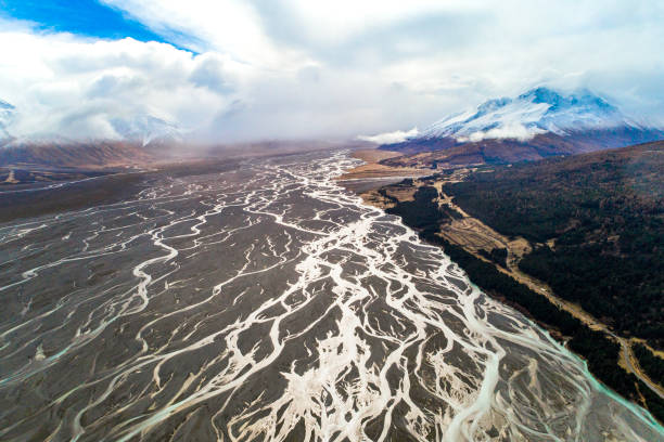 istock Aerial perspective of river braid system from glacial runoff with dramatic snow covered mountains 1497732186