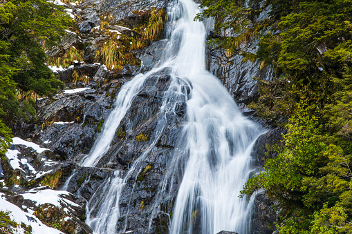 Strong and broad waterfalls flowing into a clear green pond in Puaa Kaa State Wayside Park at side of the Road to Hana Highway, Maui, Hawaii, USA.