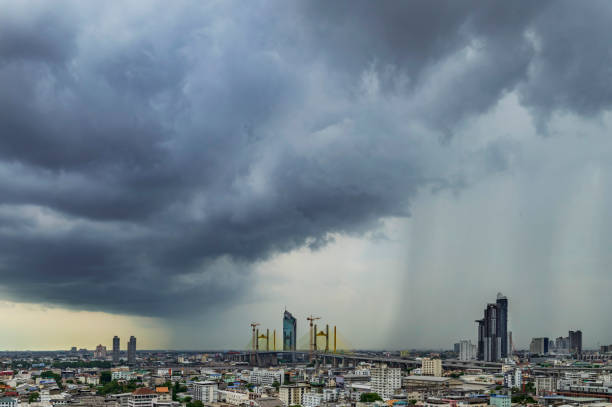 A heavy storm with rain and dramatic atmosphere clouds can be a sight to behold over a city center. stock photo