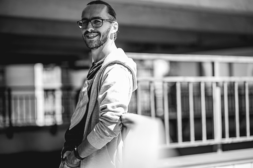 Black and white photography with beard person. Male portrait of a handsome man with eyeglasses. Lifestyle photo with nice people.