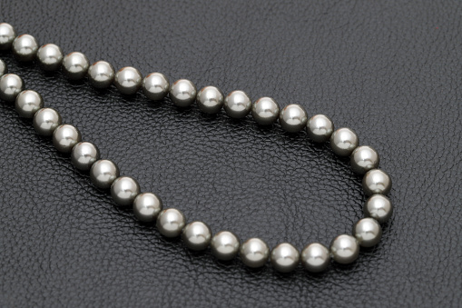 Elegant black pearl necklace on black background