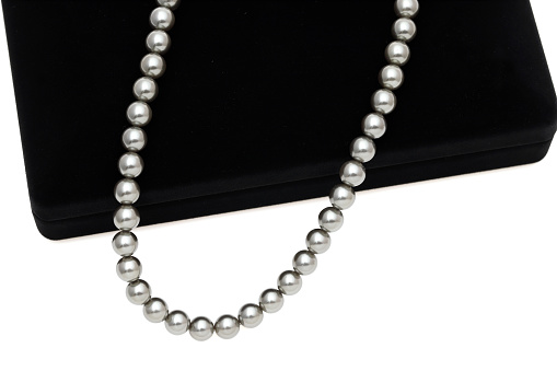 Elegant black pearl necklace on white background