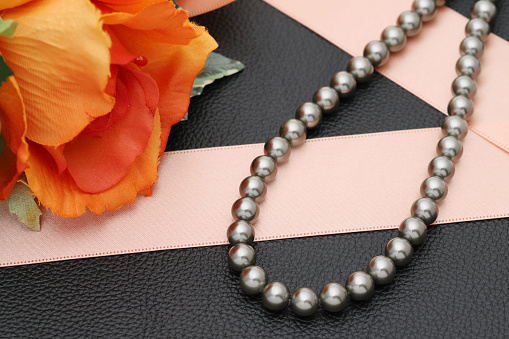 Elegant black pearl necklace on black background