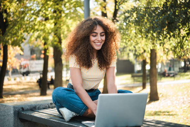 istock Beautiful girl working online from the park 1497741302