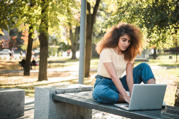 istock Beautiful girl freelancing from the park 1497741321