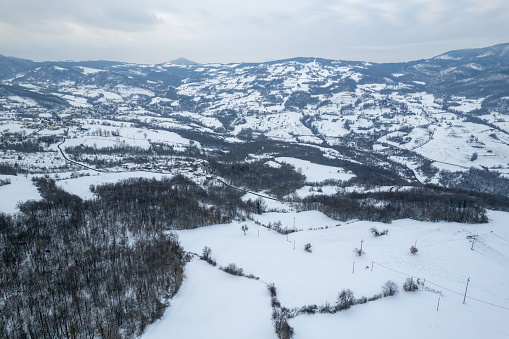 Aerial view of snowy mountain winter white landscape Vezzolacca , Emilia Romagna, Italy