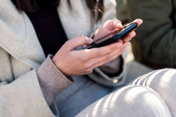 istock hand of a young woman using mobile phone 1497742201