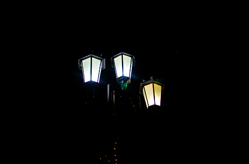 a street lamp is turned on, which glows at night. High quality lantern photo