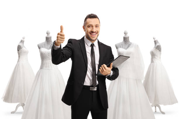 istock Man with a clipboard and documents showing thumbs up at a bridal shop 1497754015
