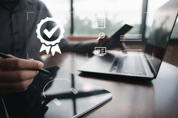 istock Businessman holding a tablet computer showcasing ISO certification and quality assurance. International standards compliance and assurance of top service is guaranteed. Digital technology is the key. 1497760352