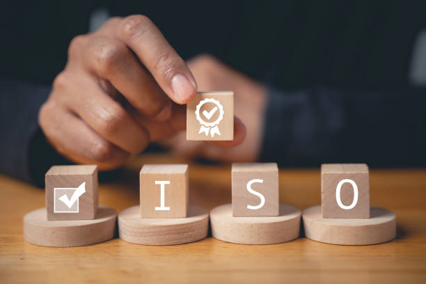 istock Businessman's finger pressing on ISO wooden cubes 1497760391