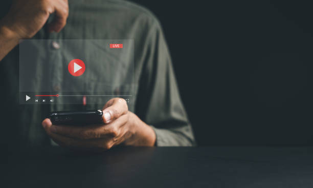 istock Man enjoying video streaming on virtual screen with a smartphone 1497760417