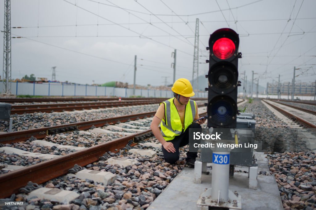 Worker checking railway signal lights Rail Transportation Stock Photo