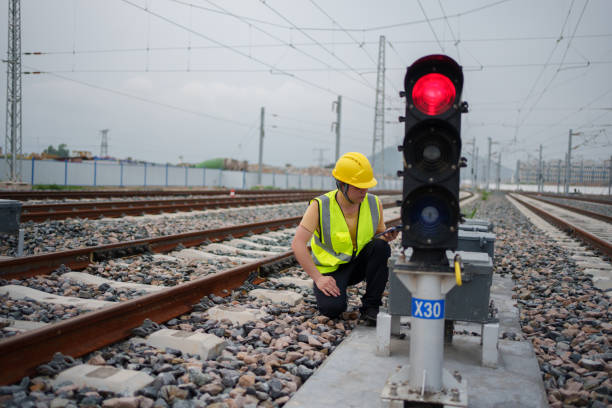 Worker checking railway signal lights Worker checking railway signal lights railway signal stock pictures, royalty-free photos & images