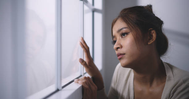 istock Asian Young woman with feels absent-minded and thoughtful with sorrow 1497761476