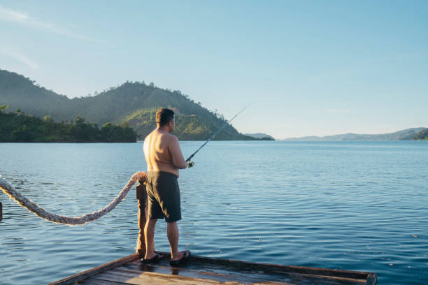 istock Man fishing at lake 1497763816