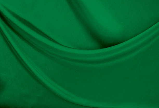 istock Black green satin dark fabric texture luxurious shiny that is abstract silk cloth background with patterns soft waves blur beautiful. 1497765911