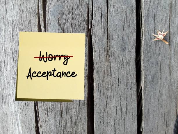 istock Yellow note on old vintage wood background with text written WORRY (crossed out) ACCEPTANCE , means to be less worry to manage anxiety and live more peaceful life 1497768300