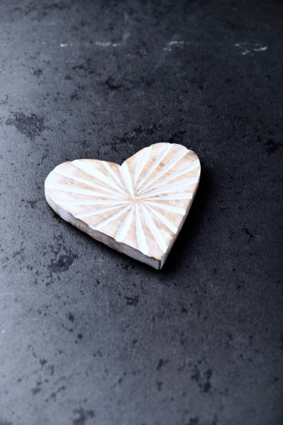 istock Wooden Heart on dark stone background. Soft focus. Copy space. 1497772589