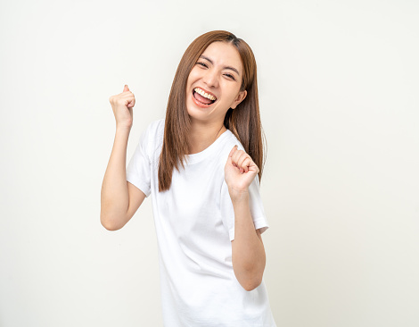 Beautiful young asian woman age around 25 smiling. Charming female standing on isolated background. People pose Excited shocked face asian woman shout out loud wow Joyful winning victory challenge