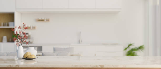 istock Close-up image of a copy space on a white marble tabletop in a modern luxury white kitchen 1497773798