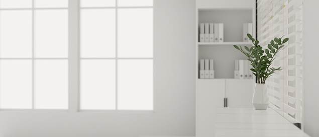 Close-up image of a copy space on a white table with a minimal white vase against the window in modern white office room. 3d render, 3d illustration