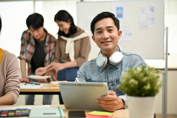 istock A male worker in a tech startup team sits at a table with a tablet in his hand 1497774901